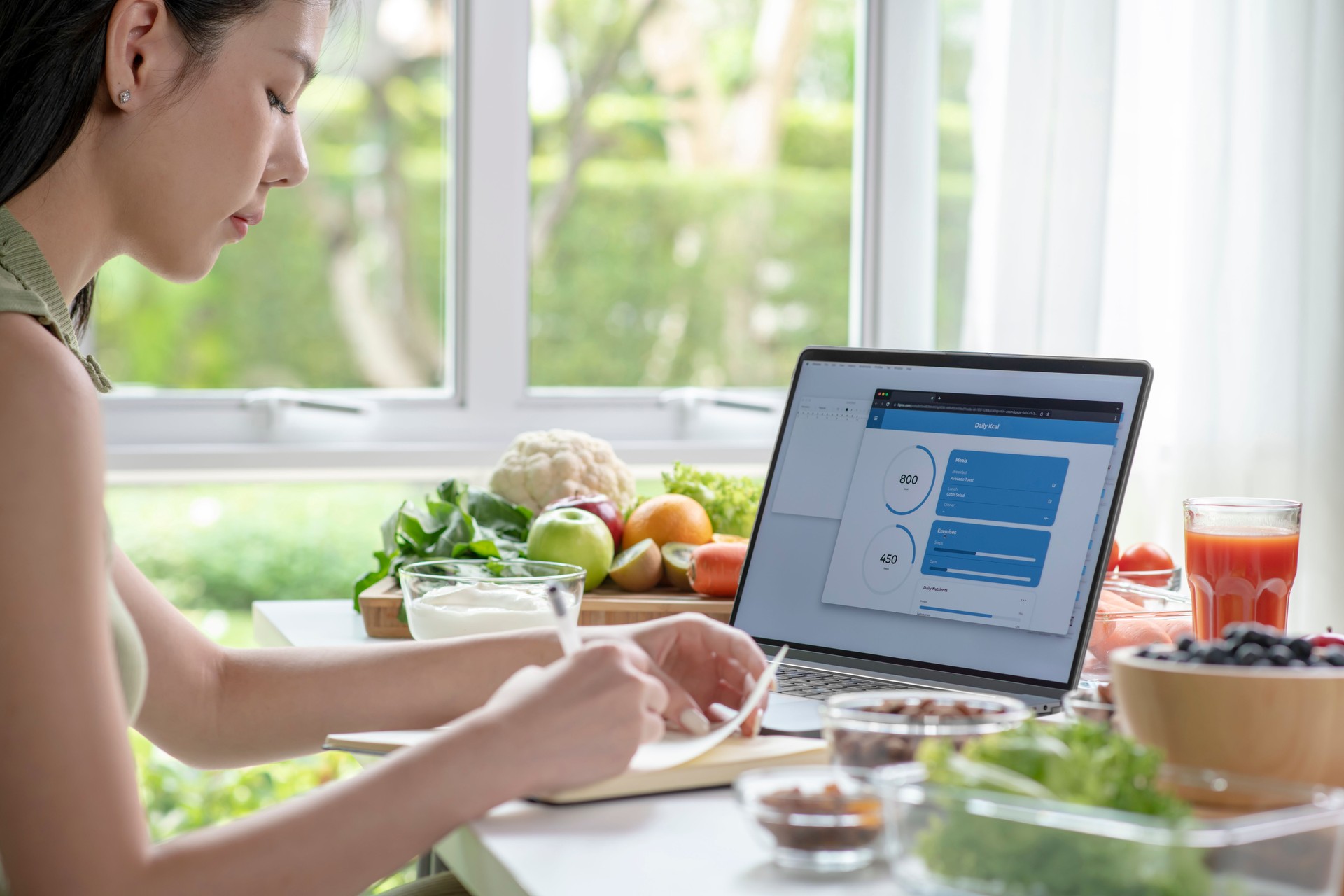 Nutritionist working and checking data from a laptop